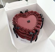 a heart shaped cake in a white box