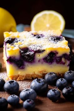 a piece of lemon blueberry cheesecake on a plate next to fresh blueberries