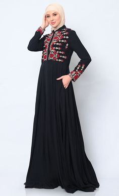 Discover the perfect fusion of elegance and practicality with our Women's Abaya, meticulously crafted to elevate your wardrobe. Featuring modern cross stitch embroidery on the bodice, this abaya exudes sophistication and timeless charm. The addition of two discreet pockets ensures functionality without compromising on style, providing ample space to keep essentials close at hand. Designed for effortless sophistication, a hidden button placket maintains a clean, streamlined front, while waist gathers create a graceful drape that enhances the figure beautifully. A refined stand collar completes the look with understated elegance, framing the face with finesse. Crafted from premium fabric, this abaya promises luxurious comfort and versatility, making it an essential piece for both formal occa Black Long Sleeve Abaya With Floral Embroidery, Embroidered Long Sleeve Modest Abaya, Modest Long Sleeve Embroidered Abaya, Black Thobe With Floral Embroidery And Long Sleeves, Black Long Sleeve Thobe With Floral Embroidery, Abaya With Pockets, Black Abaya, Modern Cross, Understated Elegance