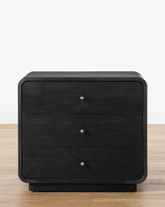 a black dresser sitting on top of a wooden floor