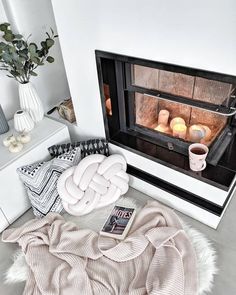 a fireplace with blankets and candles on it