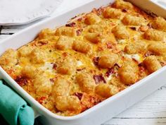 a casserole dish with meat and cheese in it sitting on a white table