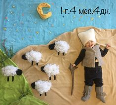 a baby is laying on a blanket with sheep