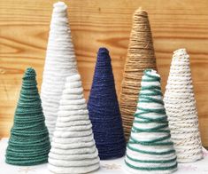 small knitted christmas trees in various colors and sizes