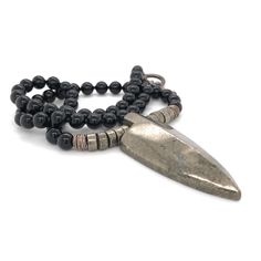 "This necklace was designed for the inner warrior with genuine Black Onyx and Pyrite 6mm beads. A large Pyrite arrow represents strength and power.  This really cool men's necklace is strung on the highest quality stainless steel beading wire for maximum strength and flexibility, then finished with a toggle clasp. Large Pyrite Arrows are approximately 2\" tall x 1 ⅞\" wide at the top. May your day be amazing, Saging Karma® 🦋 More Gemstone Necklaces https://www.etsy.com/shop/SagingKarma?ref=seller-platform-mcnav&section_id=27598570 Return to Saging Karma® shop: https://www.etsy.com/shop/SagingKarma?ref=seller-platform-mcnav Invoices will be included upon request. ✍︎  Orders totaling over $249.00 are shipped with signature required for delivery. © 2023 Saging Karma® Portland, Oregon.  All p Artisan Black Necklace With Oxidized Finish, Spiritual Silver Hematite Necklace, Adjustable Silver Obsidian Necklace, Spiritual Silver Obsidian Necklace, Spiritual Hematite Jewelry With Polished Beads, Black Hand Forged Spiritual Necklace, Black Hand-strung Amulet Jewelry, Black Warrior Style Jewelry As Gift, Black Warrior Style Jewelry For Gift