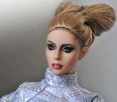 a barbie doll is dressed in blue and silver