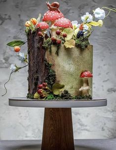 the cake is decorated with mushrooms and flowers