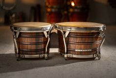 two wooden drums sitting next to each other