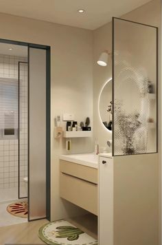 a bathroom with a walk in shower next to a sink and a mirror on the wall