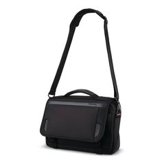 a black shoulder bag sitting on top of a white surface