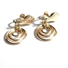 Stunning gold filled vintage earrings from the Retro period have a concentric oval hoops of square wire beneath retro fan flourishes at the ear. Really great looking worn with fitted clothing of the 40s and 50s. Length is 1.6 inches. Width is 0.6 inches. Screw back 12K gold filled earrings are made by and signed Krementz. International shoppers are responsible for all customs and import fees at checkout or upon delivery. Priority shipping upgrades available. We gift box all our jewelry.  Need yo Fitted Clothing, Gulfport Ms, Art Nouveau Antiques, Retro Fan, Dangle Hoop Earrings, Gold And Silver Rings, Gold Filled Earrings, Pearl Brooch, Gold Filled Jewelry