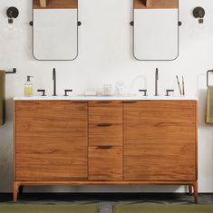 a bathroom vanity with two mirrors above it