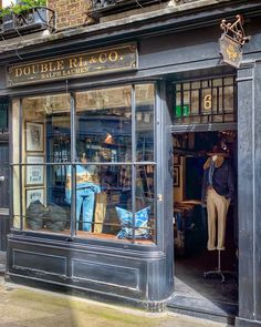 a store front with mannequins in the window