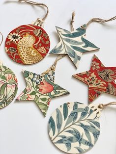 six handmade christmas ornaments are hanging on twine strings and decorated with floral designs