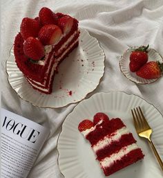 two plates with slices of red velvet cake and strawberries