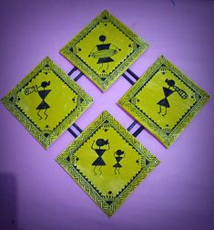 four yellow and black coasters with designs on them