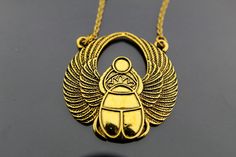 "Gold Scarab Charm Necklace, Egyptian Scarab Pendant, Scarab Charm, Egyptian Jewelry, Gold Necklace, Personalized Necklace, Customized Jewelry Gold scarab pendant charm necklace charm on high quality stainless steel chain. ♥ You will receive 1 necklace ♥ Charm Measurement Approx: 42 mm x 41 mm (1 5/8\" x 1 5/8\") ♥ Zinc Metal Alloy Pendants, Egyptian Scarab Gold Tone, Antique Gold ♥ Choose chain length from drop down menu. ♥ Shipping: A flat rate in the United States, regardless of how many item Gold Brass Charm Necklace, Handmade Gold Metal Charm Necklaces, Nickel-free Gold Brass Charm Necklaces, Handmade Gold Brass Charm Necklaces, Symbolic Gold Charm Necklaces Nickel Free, Gold Symbolic Metal Necklaces, Symbolic Gold Metal Necklace, Bronze Metal Charm Necklace Gift, Bronze Metal Charm Necklace For Gift