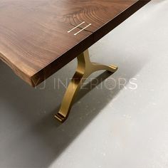 a close up of a wooden table with metal legs