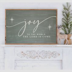 a wooden sign that says joy to the world, the lord is come on it