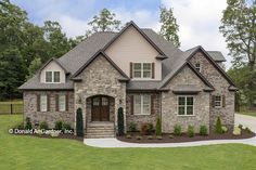 a large house with stone and brick exterior