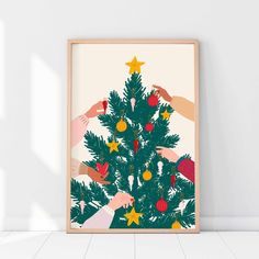 a christmas tree with hands reaching for the star on it, framed in a wooden frame