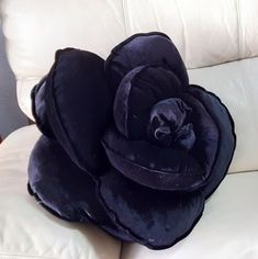 a black flower sitting on top of a white couch