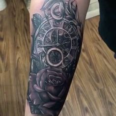 a person with a tattoo on their arm that has a clock and roses in it