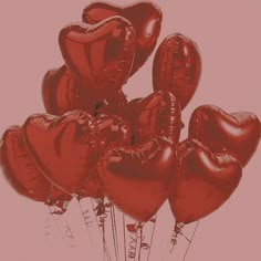 a bunch of red heart shaped balloons in the shape of hearts on a white background