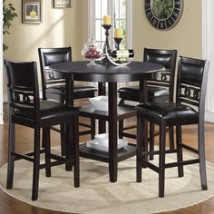 a round table with four chairs around it