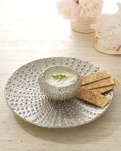 a plate with crackers and dip on it