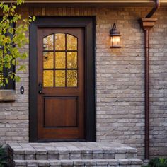 the front door to a home with stone steps