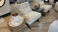 a living room filled with lots of furniture and decor on top of hard wood flooring