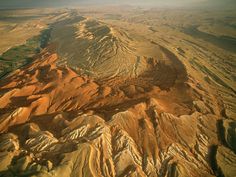 an aerial view of mountains and plains in the desert