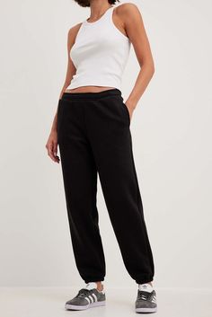 These sweatpants feature a relaxed fit, a wide leg and a soft touch. They have an elasticized waistband with an adjustable drawstring on the inside and side pockets. Our sweatpants feature elasticized hems and a brushed inside. Sweatpants Black, Future Fashion, Tracksuit Bottoms, Na Kd, Women Empowerment, Jogging, Casual Pants, Wide Leg, Sweatpants