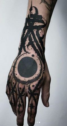 a hand with black ink on it that has a bike in the middle and circles around it