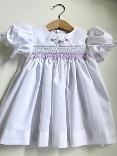 Fitted Embroidered Baptism Dress For Spring, Spring Embroidered Fitted Baptism Dress, Fitted Embroidered Spring Baptism Dress, Spring Baptism Dress Embroidered And Fitted, Elegant White Smocked Dress With Lace Trim, Embroidered Fitted Baptism Dress For Summer, Fitted Embroidered Baptism Dress For Summer, Summer Embroidered Fitted Baptism Dress, Elegant Smocked Dress With Smocked Cuffs For Baptism