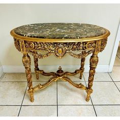 an ornately decorated table with marble top