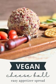 A side view of a vegan cheese ball placed on a wooden surface, surrounded by an assortment of crackers and fresh vegetables. Vegan Cheese Ball, Holiday Party Game, Vegan Appetizer, Dairy Free Cheese, Vegan Appetizers, Cheese Ball