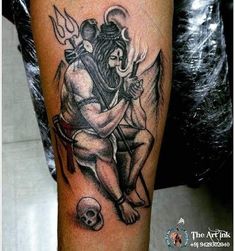 a tattoo on the leg of a man with an angel and skull sitting next to him