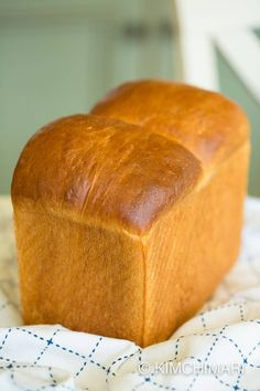 a loaf of bread sitting on top of a bed