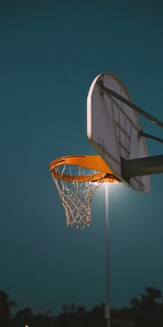 a basketball going through the hoop at night