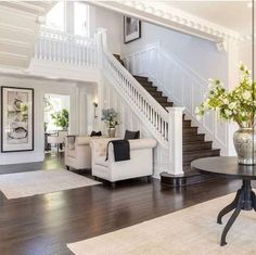 a living room filled with furniture and a staircase