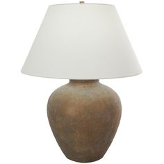 a brown vase with a white shade on it's side and a light in the middle