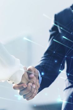 two people shaking hands over a digital background