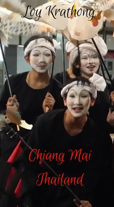 some people wearing masks and holding umbrellas in front of their faces with the words, joy kratong chiang mai thailand