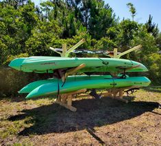 three kayaks are stacked on top of each other