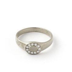 a silver ring with white stones on it's side and an oval design in the middle