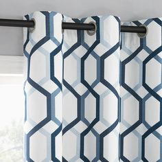 a window with blue and white geometric curtains