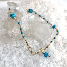 Beautiful Sleeping Beauty Heshi Turquoise beads (that amazing bright blue color) are stationed along this dainty rosary style chain with tiny 2mm Turquoise round beads.Entire bracelet is hand-wrapped to keep it secure. Finished off with a dangle of the same pretty Sleeping Beaty Heshi Turquoise beads, gold filled beads and spring ring clasp. Length is adjustable from 6 3/4" - 7 1/4". Great simple bracelet for everyday, December Birthdays, date night! Great layering bracelet. Bright Blue Color, December Birthday, Simple Bracelets, Sleeping Beauty Turquoise, Hand Wrap, Layered Bracelets, Turquoise Beads, Bright Blue, Spring Rings