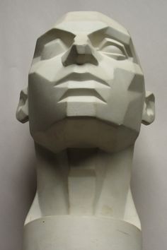 a sculpture of a man's head is shown against a white background